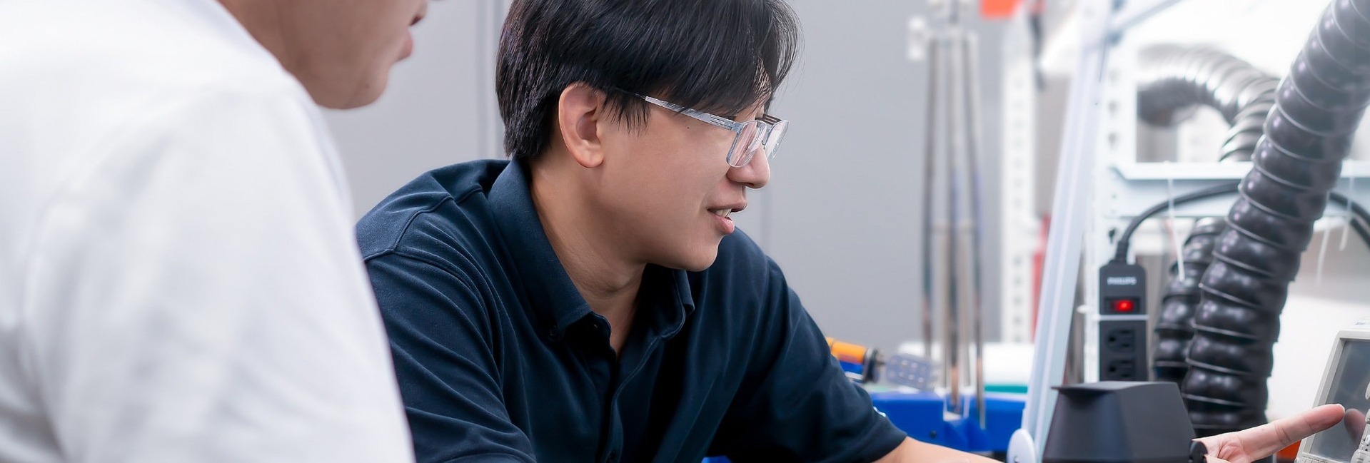 Engineers reviewing a benchtop life science instrument prototype in the lab